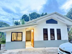a white house with a driveway at Bustrillos Guesthouse in Tagbilaran City