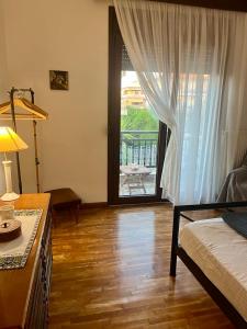 a room with a bed and a door to a patio at Second Home Ierissos in Ierissos