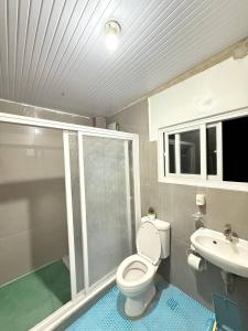 a bathroom with a toilet and a sink at Mountain Cove Villa in Pagudpud +5 photos