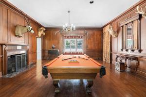 a pool table in a large room with wooden walls at WestWind Estate in Spartanburg