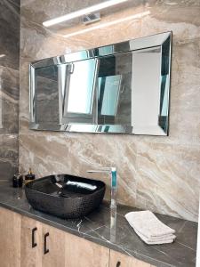a bathroom with a black sink and a mirror at City Lights - Luxury Penthouse - Panoramic view - Near Unic in Nicosia +32 photos
