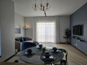 a living room with a table and a couch at ليالينا فيو Layali View Family and Business 3 bed rooms 13 in King Abdullah Economic City