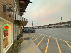 a car parked in a parking lot next to a building at Silver crest lodge in Grande Prairie