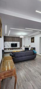 a large living room with a couch and a table at A Story Worth Staying In in Shkodër