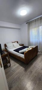 a bedroom with a bed in a room with a window at A Story Worth Staying In in Shkodër