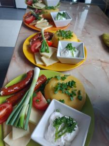 two plates of food on a table with different foods at Pensiunea Keisd in Saschiz +91 photos