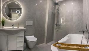 a bathroom with a tub and a sink and a mirror at Ferienwohnung in Frankenthal
