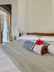 a bedroom with a bed with two pillows on it at Kôsy in Grand-Bourg