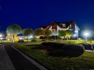 a house on a street at night at Perla Mare Apartamenty in Krynica Morska