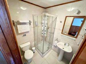 a bathroom with a shower and a toilet and a sink at CHALET CHAPITAL Punta Arenas in Punta Arenas +29 photos