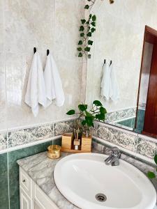 a bathroom with a sink and a mirror at Pink House - Lisbon in Lisbon +16 photos