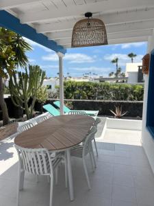 a wooden table and chairs on a patio at Paraíso Marino in Tías
