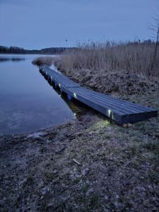 a long dock on the side of a lake at Telšu vieta Sīvera Medniekkrasti 