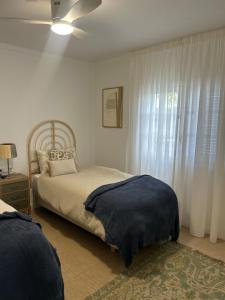 a bedroom with a bed and a ceiling fan at Paraíso Marino in Tías