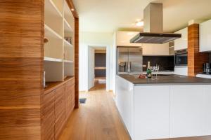 a kitchen with white cabinets and a counter top at Modersnhof - Landhaus Idylle in Weiz +27 photos