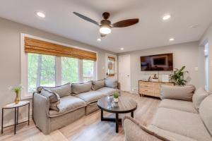 a living room with a couch and a tv at Game Room and Deck Family Home in Tobyhanna! in Tobyhanna
