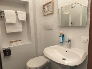a bathroom with a white toilet and a sink at Lerici Charme in Lerici