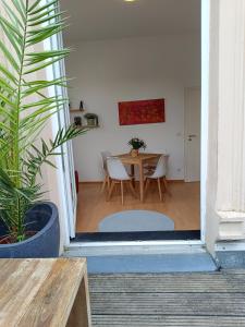 a living room with a table and a dining room at Wohnung am Schlosspark in Bendorf +12 photos
