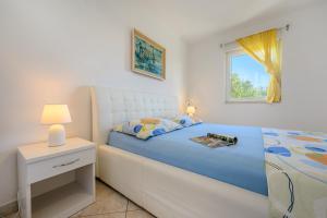 Katil atau katil-katil dalam bilik di Villa Tina