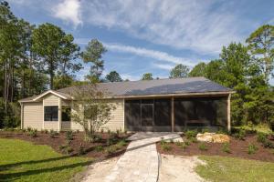a house with a solar roof on top of it at Black Prong Resort in Bronson