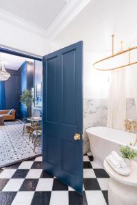 a bathroom with a blue door and a tub at French Quarter Mansion in New Orleans +161 photos