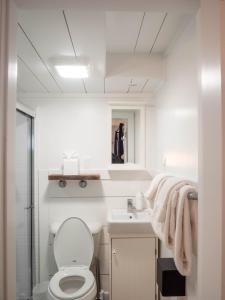 a white bathroom with a toilet and a sink at Stones Throw in York Beach