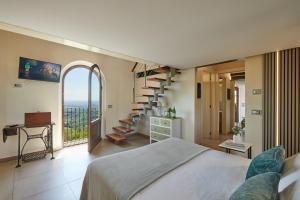 a bedroom with a bed and a spiral staircase at Podere Raffanna Ecologic House in Massa e Cozzile +58 photos