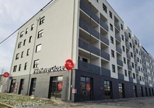 a white building with a sign on the side of it at Dream Apartment VG - Self Check in - Garage in Velika Gorica