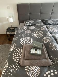 a bed with two pillows and a box of candles on it at Dream Apartment VG - Self Check in - Garage in Velika Gorica