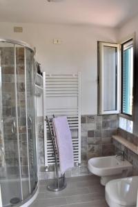 a bathroom with a shower and a toilet and a sink at Cottage with large terrace in Corropoli