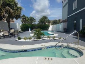 a swimming pool in front of a building at Wingate by Wyndham Kings Bay Naval Base I-95 in Kingsland