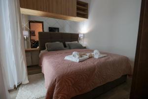 Postel nebo postele na pokoji v ubytování Zeus Apartman