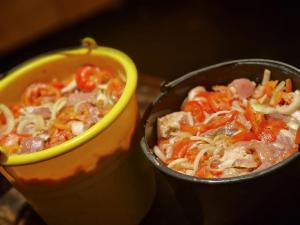 a bowl of soup with meat and vegetables at Puķkalniñš in Ventspils