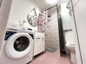 a bathroom with a washing machine and a toilet at Studio Navae in Năvodari