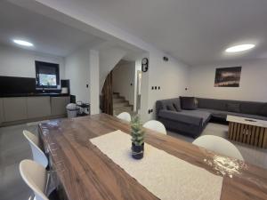 a living room with a table and a couch at Forza Blidinje in Blidinje