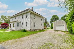 an old white house with a garage at Walk to Downtown Wakefield Haven Near Beaches in South Kingstown