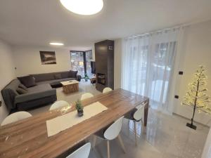 a living room with a table and a couch at Forza Blidinje in Blidinje +28 photos
