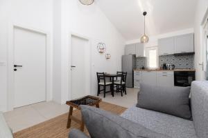a kitchen and living room with a couch and a table at Nonna Vittoria 2 in Mali Lošinj