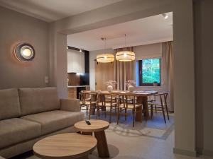 a living room with a couch and a table and chairs at Sileo Nature in Ustka