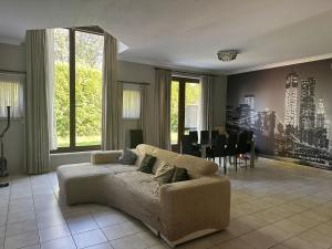 a living room with a couch and a dining room at Beautiful 4 bedroom Villa close to Antwerp in Zwijndrecht