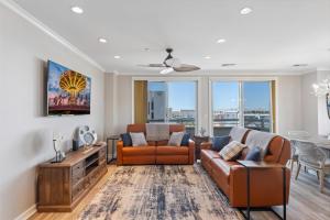 a living room with a couch and chairs and a table at Residence 404 At The Grand in Wildwood