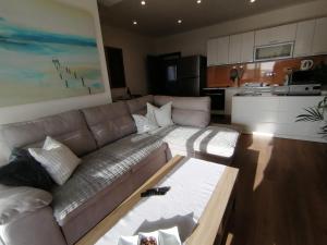 a living room with a couch and a kitchen at Apartments Knežević in Ulcinj