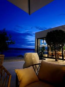 a living room with a couch and a view of the ocean at Apartman Lucia in Mimice +11 photos