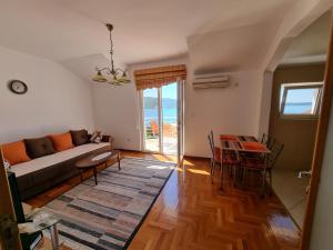 a living room with a couch and a table at Apartment Brace Grakalica 20b in Herceg-Novi