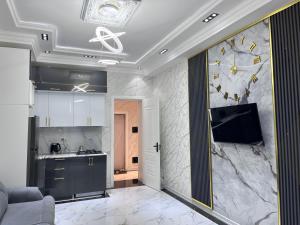 a kitchen with a large clock on the wall at Delmar resıdence in Mekhrably
