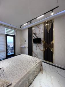 a bedroom with a large bed and a large window at Delmar resıdence in Mekhrably +10 photos