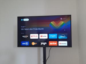 a flat screen tv on a stand with different apps at Design-Loft mit 2 Balkonen am Stadtwald - 20 min zur Messe Düsseldorf in Krefeld