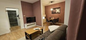 a living room with a couch and a table at Ferienwohnung Helene in Gotha