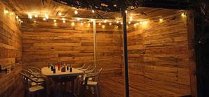 a dining room with a table and chairs and lights at Maison Parentis en Born 6-8 personnes-L'échappée landaise in Parentis-en-Born
