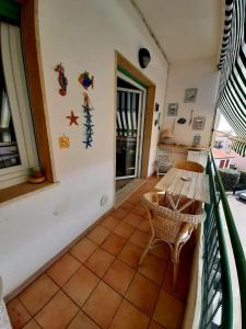 a balcony with a wooden table and a table at Vista bella in Castiglione della Pescaia +8 photos